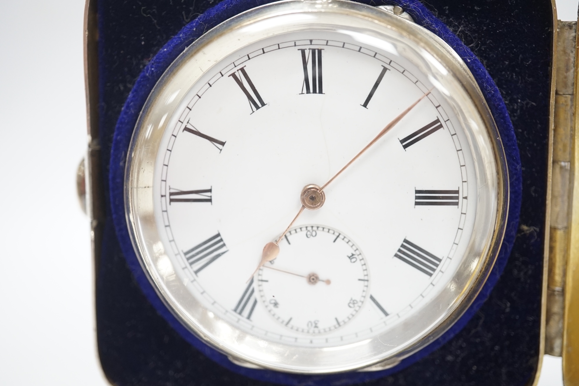 An Edwardian silver travelling pocket watch case, Birmingham, 1904, on bun feet, containing a Swiss white metal open face pocket watch. Condition - fair